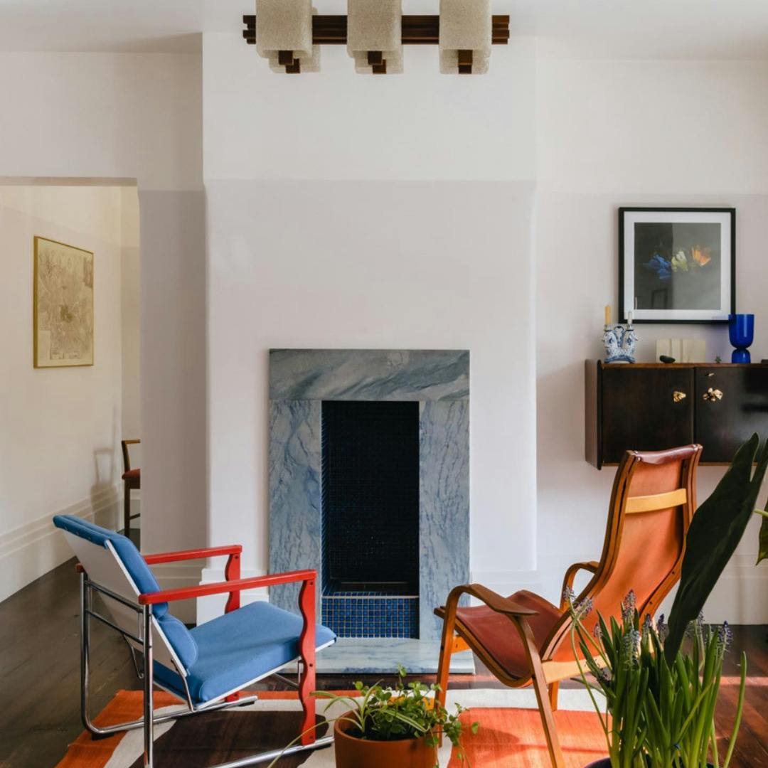 A modern living room with two chairs facing a fireplace